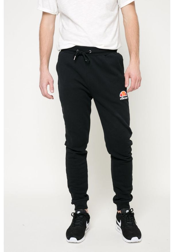 Ellesse - Spodnie. Kolor: czarny. Materiał: dzianina. Wzór: gładki
