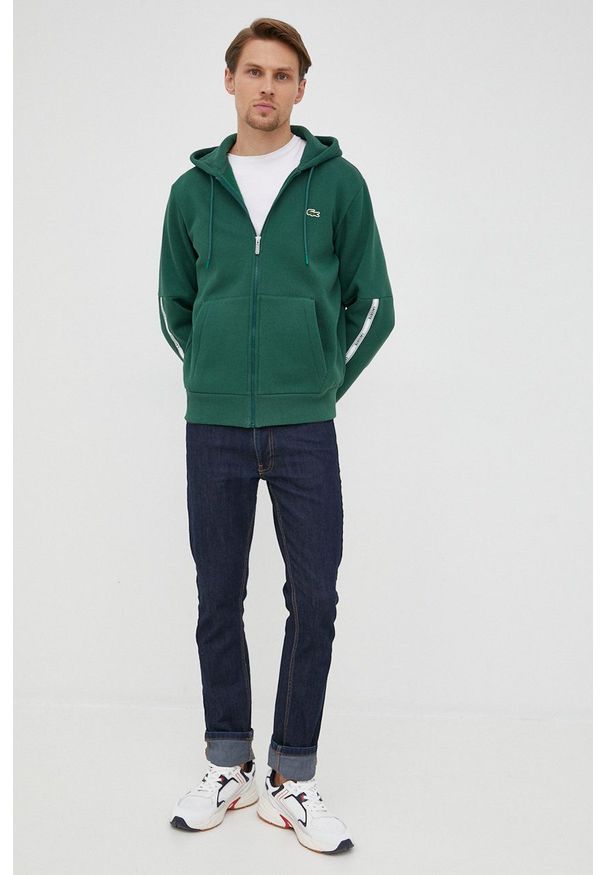 Lacoste bluza męska kolor zielony z kapturem z aplikacją. Okazja: na co dzień. Typ kołnierza: kaptur. Kolor: zielony. Materiał: dzianina. Wzór: aplikacja. Styl: casual
