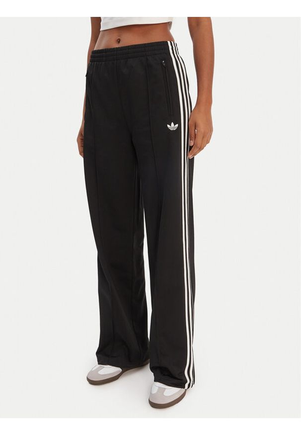 Adidas - adidas Spodnie dresowe Firebird KD7976 Czarny Loose Fit. Kolor: czarny. Materiał: syntetyk