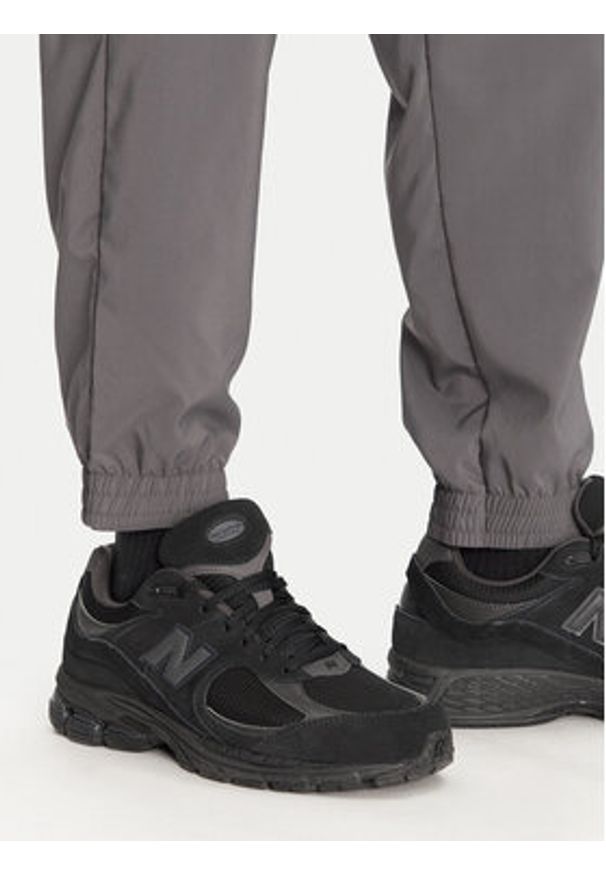 Adidas - adidas Spodnie dresowe Essentials Small Logo JD1822 Szary Regular Fit. Kolor: szary. Materiał: syntetyk