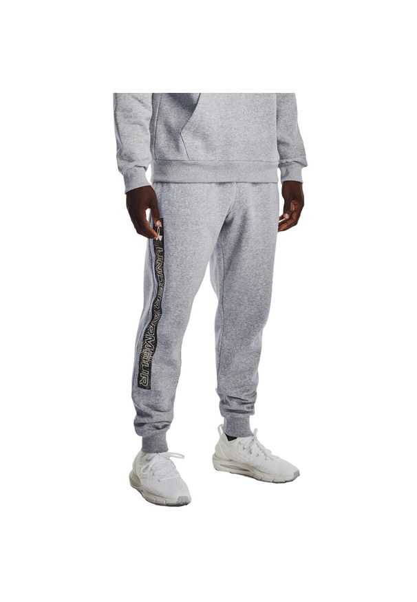 Spodnie sportowe męskie Under Armour Rival. Kolor: szary. Materiał: dresówka. Styl: sportowy. Sport: piłka nożna