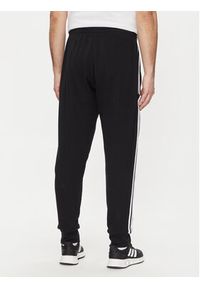 Adidas - adidas Spodnie dresowe Essentials French Terry Tapered Cuff 3-Stripes Joggers HA4337 Czarny Regular Fit. Kolor: czarny. Materiał: bawełna