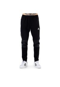 Adidas - Spodnie adidas Tiro Winterized H33688 - czarne. Kolor: czarny. Materiał: bawełna, poliester, polar, materiał, dresówka. Wzór: aplikacja, paski. Sport: piłka nożna, fitness