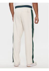 New Balance Spodnie dresowe Greatest Hits MP41504 Beżowy Regular Fit. Kolor: beżowy. Materiał: bawełna