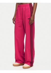 Adidas - adidas Spodnie dresowe Firebird Loose Tracksuit KW0228 Różowy Loose Fit. Kolor: różowy. Materiał: syntetyk #1