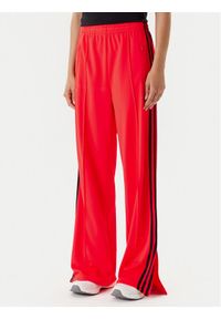 Adidas - adidas Spodnie dresowe adicolor Classic Firebird JW1227 Pomarańczowy Loose Fit. Kolor: pomarańczowy. Materiał: syntetyk #1