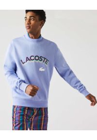 Lacoste - LACOSTE - Fioletowa bluza z logo 3D Unisex Fit. Kolor: różowy, wielokolorowy, fioletowy. Materiał: prążkowany. Wzór: aplikacja #5