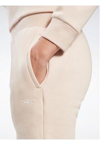 Reebok Spodnie dresowe Fleece IC3502 Beżowy Slim Fit. Kolor: beżowy. Materiał: bawełna, syntetyk