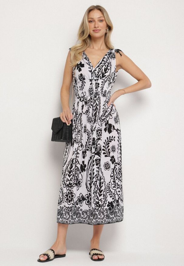 Born2be - Czarna Sukienka z Roślinnym Wzorem i Kopertowym Dekoltem z Gumką w Talii Orrune. Okazja: na co dzień, na spotkanie biznesowe, do pracy. Typ kołnierza: dekolt kopertowy. Kolor: czarny. Materiał: jeans. Sezon: lato. Typ sukienki: kopertowe. Styl: casual, biznesowy, klasyczny