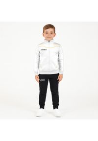 LEGEA - Komplet dresowy dla chłopca TEXAS JUNIOR JR. Okazja: na uczelnię. Kolor: żółty, wielokolorowy, biały. Materiał: dresówka. Styl: sportowy #1