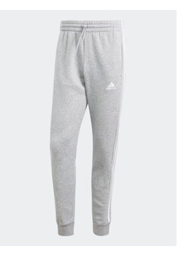 Adidas - adidas Spodnie dresowe Essentials Fleece 3-Stripes Cuff IJ6494 Szary Regular Fit. Kolor: szary. Materiał: bawełna