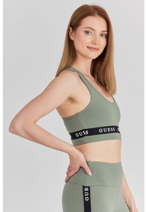 Guess - GUESS Zielony top sportowy damski z logo, Rozmiar L. Kolor: zielony. Materiał: bawełna. Styl: sportowy