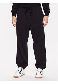Tommy Jeans Spodnie dresowe Solid Badge DM0DM16336 Czarny Relaxed Fit. Kolor: czarny. Materiał: bawełna, dresówka #1