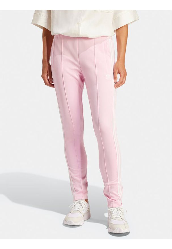 Adidas - adidas Spodnie dresowe adicolor SST IR8076 Różowy Slim Fit. Kolor: różowy. Materiał: bawełna