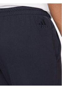 Adidas - adidas Spodnie dresowe Essentials HA4344 Granatowy Regular Fit. Kolor: niebieski. Materiał: bawełna