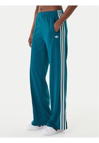Adidas - adidas Spodnie dresowe Firebird KG3701 Zielony Loose Fit. Kolor: zielony. Materiał: syntetyk #1