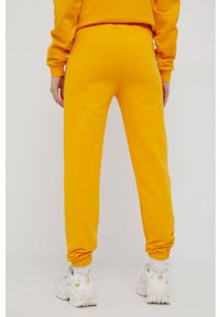 ARKK Copenhagen - Arkk Copenhagen spodnie dresowe bawełniane kolor żółty gładkie. Kolor: żółty. Materiał: bawełna, dresówka. Wzór: gładki #4