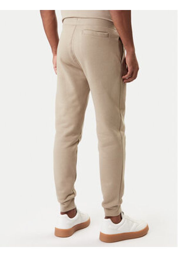Guess Spodnie dresowe Z2YB22 K9V31 Beżowy Regular Fit. Kolor: beżowy. Materiał: bawełna