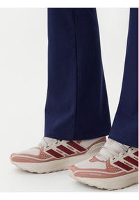Adidas - adidas Legginsy Essentials Small Logo JD3073 Granatowy Flare Fit. Kolor: niebieski. Materiał: bawełna