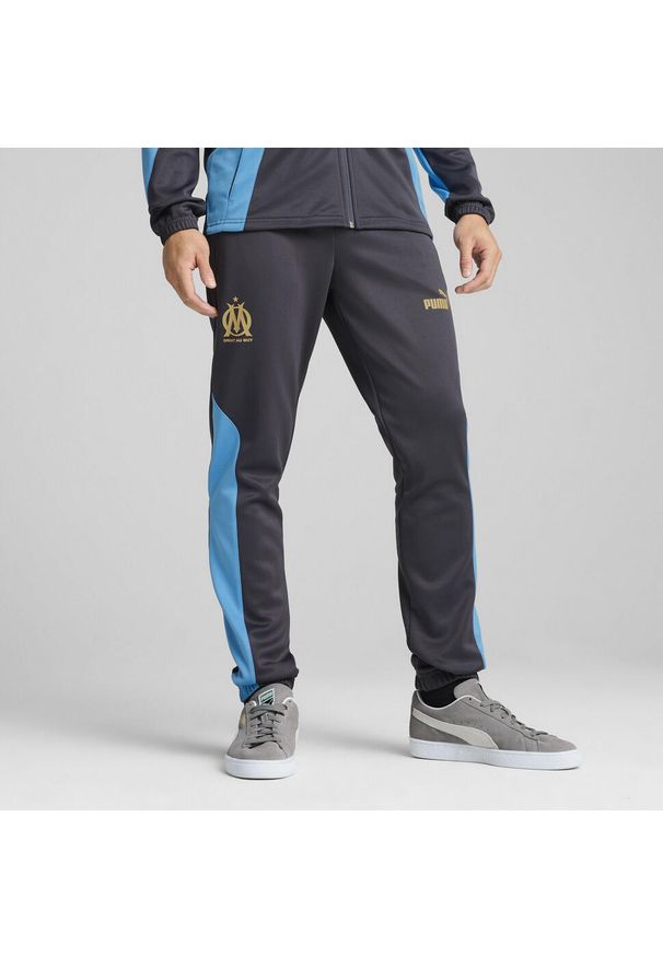 Puma - Męskie spodnie Olympique de Marseille ftblNRGY+ PUMA. Kolor: szary, wielokolorowy, beżowy. Materiał: dresówka. Sport: piłka nożna