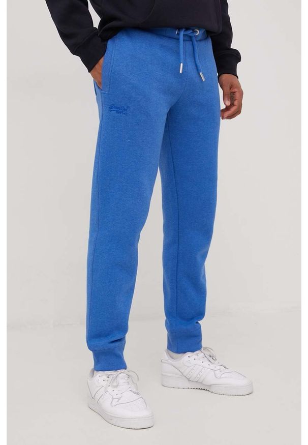 Superdry spodnie dresowe męskie melanżowe. Kolor: niebieski. Materiał: dresówka. Wzór: melanż