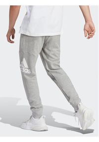 Adidas - adidas Spodnie dresowe Essentials HA4345 Szary Regular Fit. Kolor: szary. Materiał: bawełna