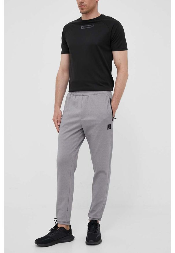 Hummel spodnie dresowe Interval kolor szary gładkie. Kolor: szary. Materiał: dresówka. Wzór: gładki