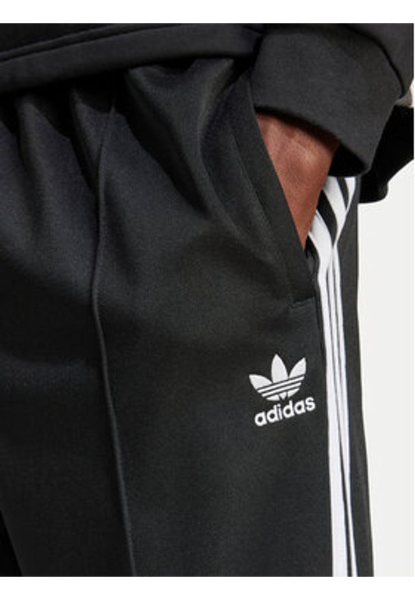 Adidas - adidas Spodnie dresowe adicolor Firebird IZ4801 Czarny Baggy Fit. Kolor: czarny. Materiał: bawełna