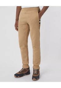 Burberry - BURBERRY - Beżowe spodnie z panelami w kratkę. Kolor: beżowy. Materiał: bawełna. Wzór: kratka