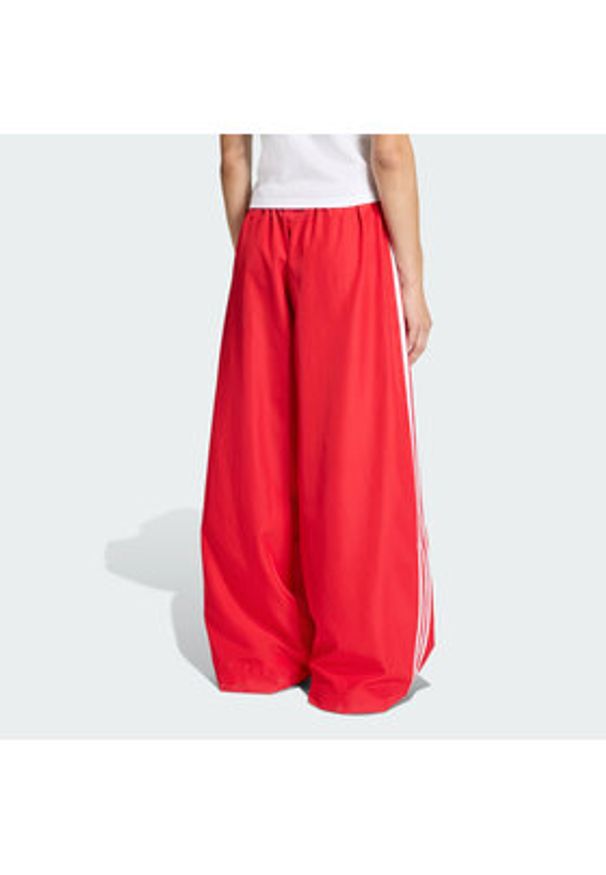 Adidas - adidas Spodnie dresowe Firebird Adilenium KD6299 Czerwony Regular Fit. Kolor: czerwony. Materiał: syntetyk