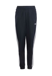 Adidas - adidas Spodnie dresowe adicolor SST KE2862 Czarny Regular Fit. Kolor: czarny. Materiał: syntetyk #6