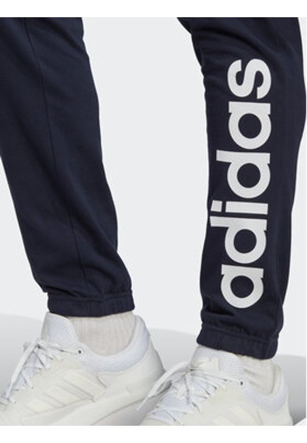 Adidas - adidas Spodnie dresowe Essentials IC0056 Granatowy Regular Fit. Kolor: niebieski. Materiał: bawełna, syntetyk