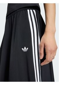 Adidas - adidas Spodnie dresowe Firebird Skirt KR6663 Czarny Relaxed Fit. Kolor: czarny. Materiał: syntetyk #3