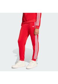 Adidas - adidas Spodnie dresowe adicolor SST KE2861 Czerwony Regular Fit. Kolor: czerwony. Materiał: syntetyk #1