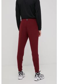 New Balance spodnie dresowe MP11143GTH męskie kolor bordowy melanżowe. Kolor: czerwony. Materiał: dresówka. Wzór: melanż #4