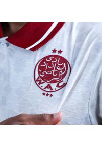 Kappa - Zewnętrzny strój Wydad AC 2025/26. Kolor: czerwony, biały, wielokolorowy. Sport: piłka nożna
