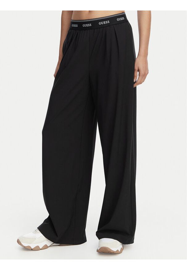 Guess Spodnie dresowe V6GB08 W1771 Czarny Relaxed Fit. Kolor: czarny. Materiał: syntetyk