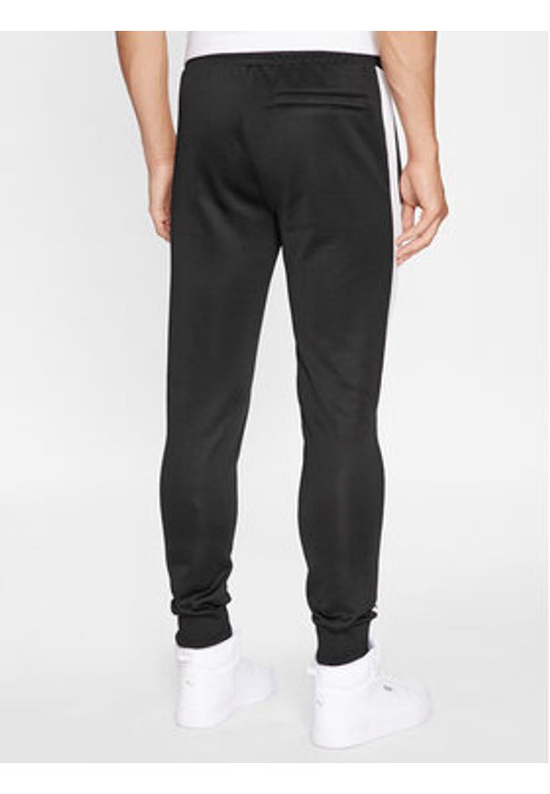 Puma Spodnie dresowe Iconic T7 530098 Czarny Regular Fit. Kolor: czarny. Materiał: bawełna