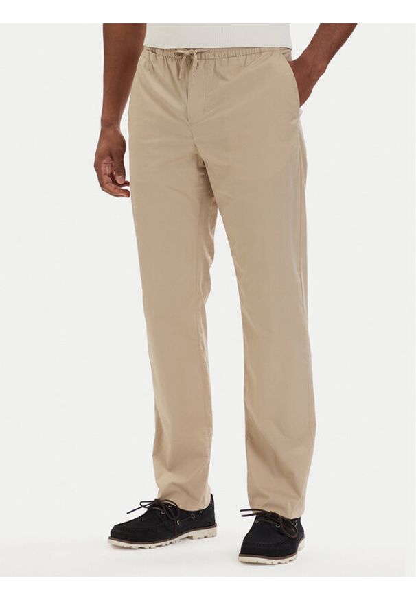 TOMMY HILFIGER - Tommy Hilfiger Chinosy Denton MW0MW42340 Beżowy jasny Slim Fit. Kolor: beżowy. Materiał: bawełna