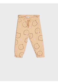 Sinsay - Spodnie dresowe jogger - beżowy. Kolor: beżowy. Materiał: dresówka #1