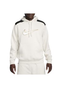 Bluza Nike Sportswear FLC FN0247-104 - beżowa. Typ kołnierza: kaptur. Kolor: beżowy. Materiał: poliester, materiał, bawełna. Wzór: aplikacja. Styl: klasyczny