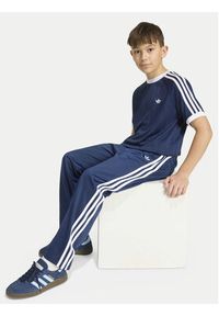 Adidas - adidas Spodnie dresowe Firebird HZ6650 Granatowy Regular Fit. Kolor: niebieski. Materiał: syntetyk #7