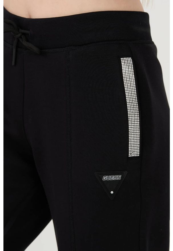 Guess - GUESS Czarne damskie spodnie dresowe Kiara Pant, Rozmiar S. Kolor: czarny. Materiał: dresówka