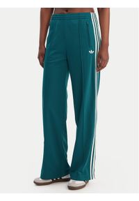 Adidas - adidas Spodnie dresowe Firebird KG3701 Zielony Loose Fit. Kolor: zielony. Materiał: syntetyk #1