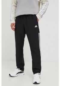 Adidas - adidas spodnie dresowe męskie kolor czarny z aplikacją. Kolor: czarny. Materiał: dresówka. Wzór: aplikacja #1