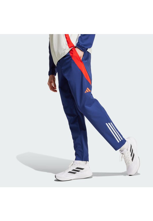 Adidas - Spodnie Olympique Lyonnais Tiro 24 Presentation. Kolor: czerwony, niebieski, wielokolorowy, biały. Materiał: dresówka, materiał. Sport: piłka nożna