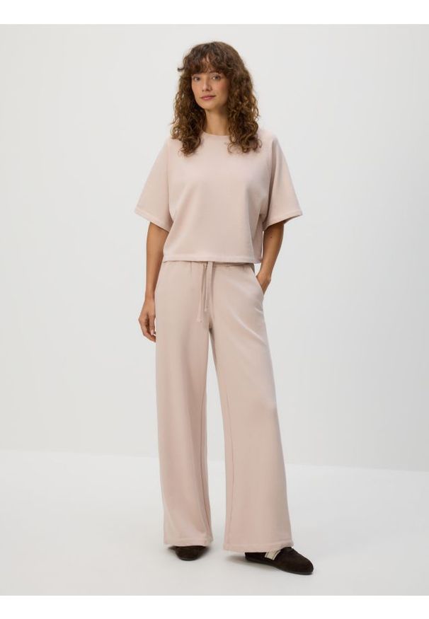 Reserved - Bawełniane spodnie dresowe - pastelowy róż. Kolor: różowy. Materiał: bawełna, dresówka