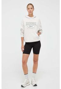 Reebok Classic bluza bawełniana damska kolor beżowy z kapturem z aplikacją. Typ kołnierza: kaptur. Kolor: beżowy. Materiał: bawełna. Długość rękawa: długi rękaw. Długość: długie. Wzór: aplikacja #4