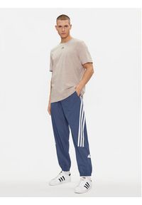 Adidas - adidas Spodnie dresowe Future Icons 3-Stripes IR9239 Niebieski Slim Fit. Kolor: niebieski. Materiał: syntetyk