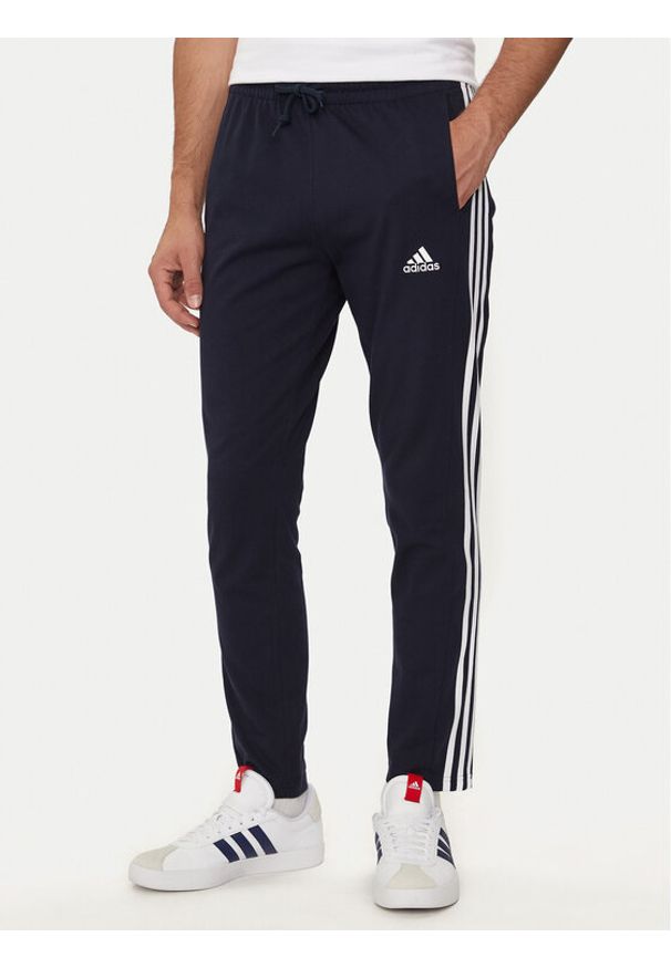 Adidas - adidas Spodnie dresowe Essentials IC0045 Granatowy Regular Fit. Kolor: niebieski. Materiał: bawełna, syntetyk